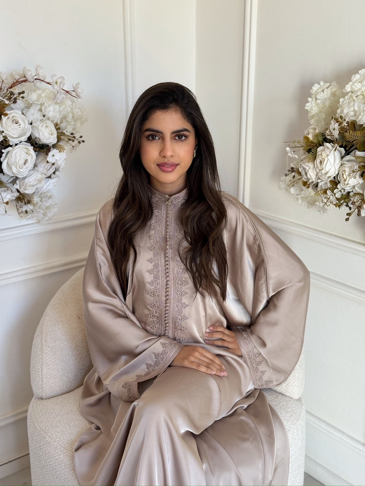 Woman wearing an elegant Moroccan gandoura with a flowing and modest design.