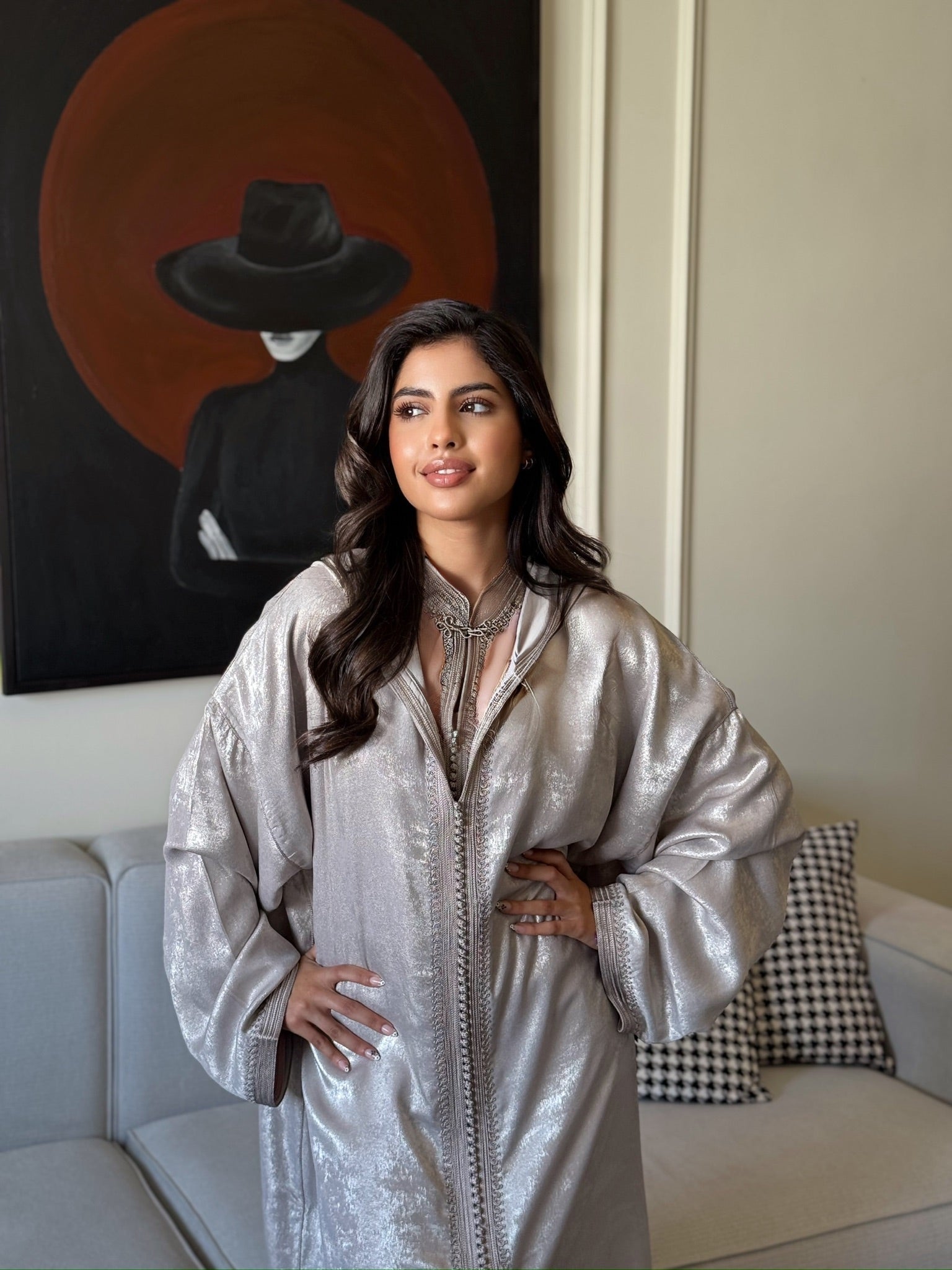 Woman wearing a beige jellaba with wide sleeves and elegant detailing
