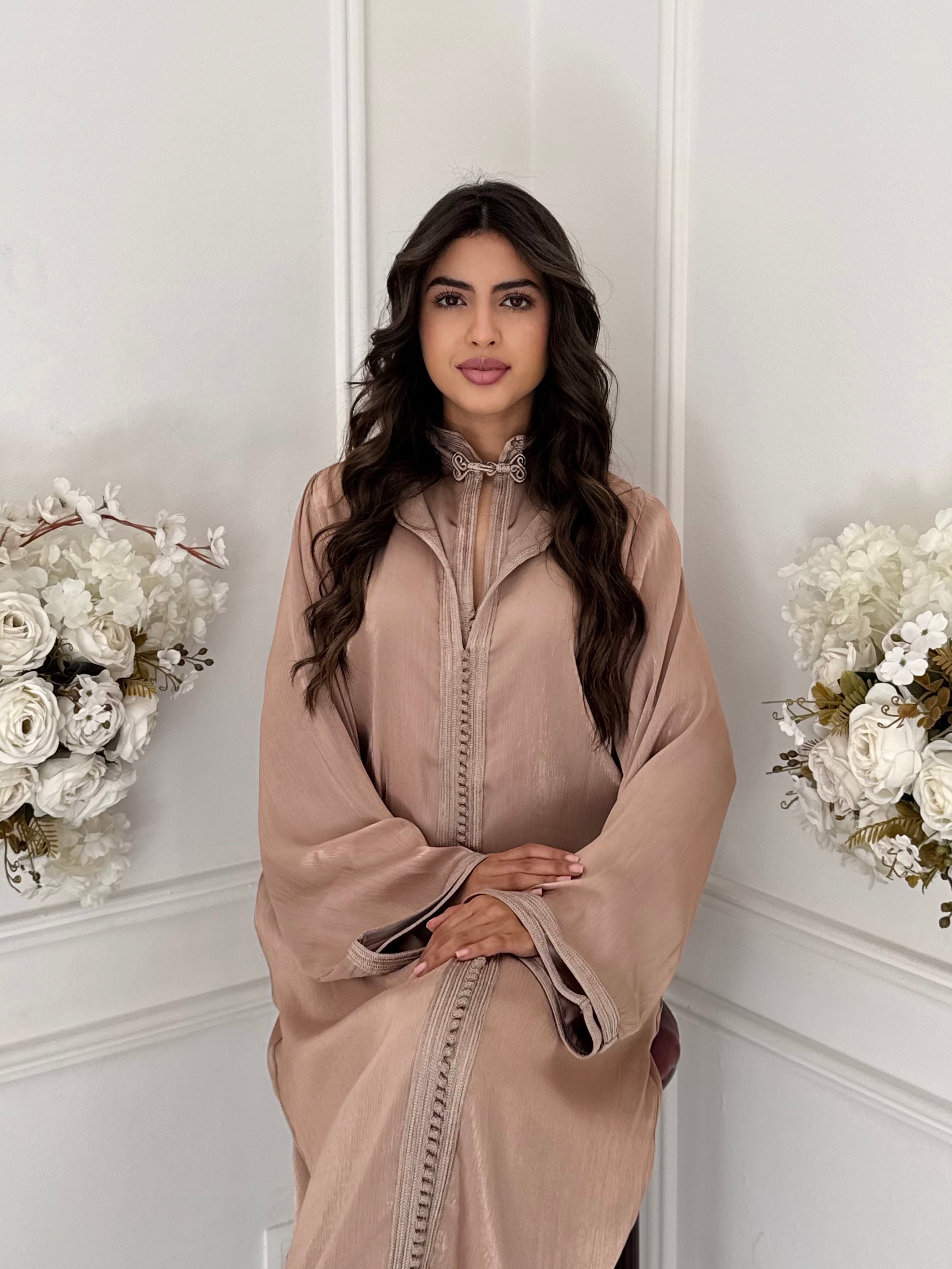 Model wearing Jellaba Habiba — beige Moroccan jellaba made from soft silk fabric.