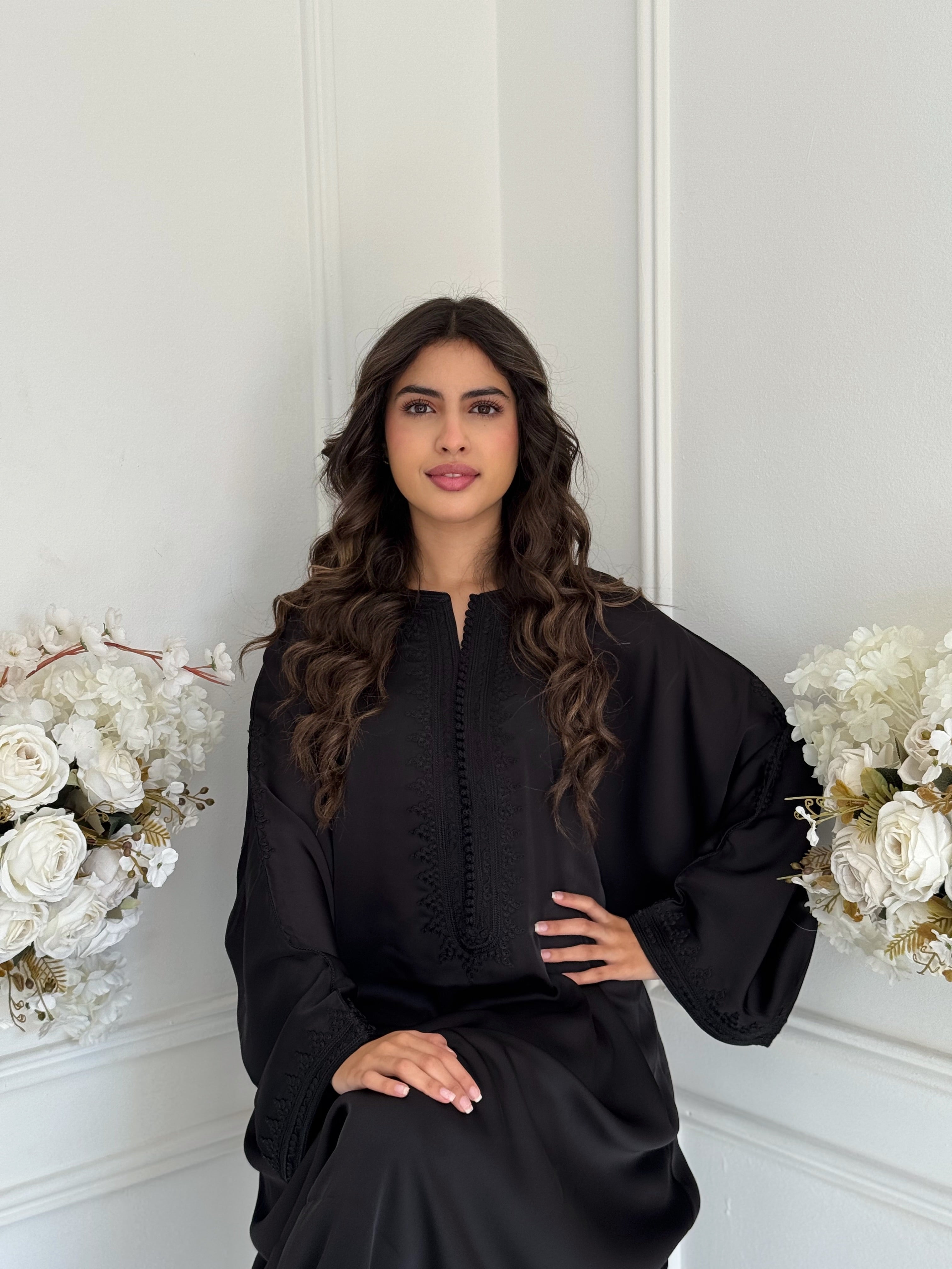 Close-up of Gandoura Rahma neckline embroidery and Arabic detailing.